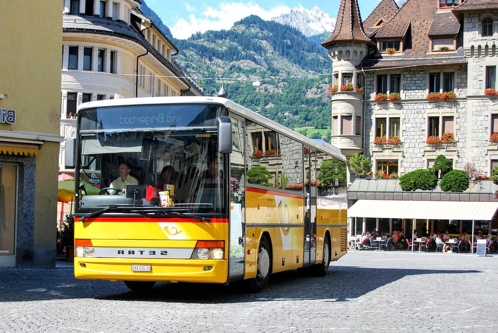 Modern bus traveling on a highway through scenic landscape