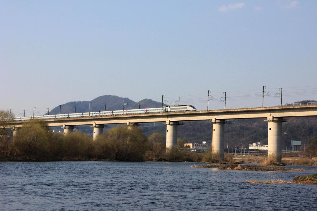 High-speed train moving through scenic landscape
